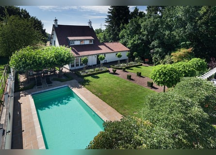 Exquisite private equestrian estate featuring an indoor arena, stables, and a luxurious residence