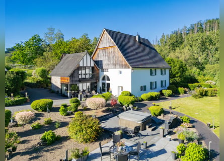 Private riding facility with a historic residential building in a picturesque setting