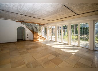 Exclusive estate with a villa, riding facilities, and an indoor arena complex located by a private l