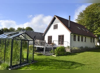 Renovated residential building with six horse stalls, riding area, and pastures enclosed by wooden f