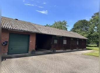 Spacious country house with equestrian facilities, riding arena, and a stunning park-like garden in 