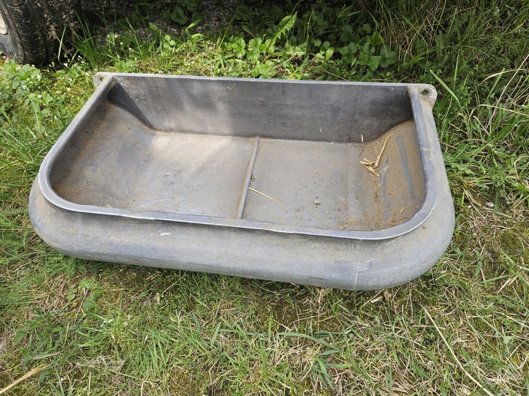 Two cast iron feed troughs