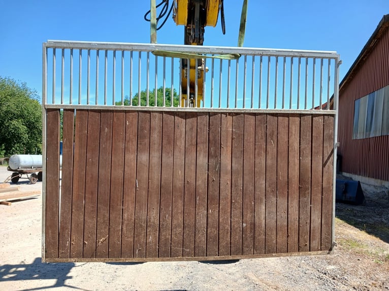 Well-preserved box stall walls made of bongossi wood, galvanized