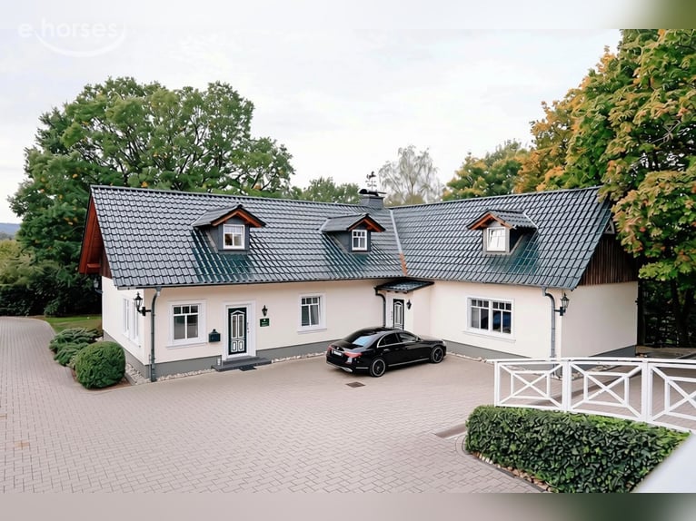 Exclusive equestrian facility with a detached house and two residential/guest houses on approximatel