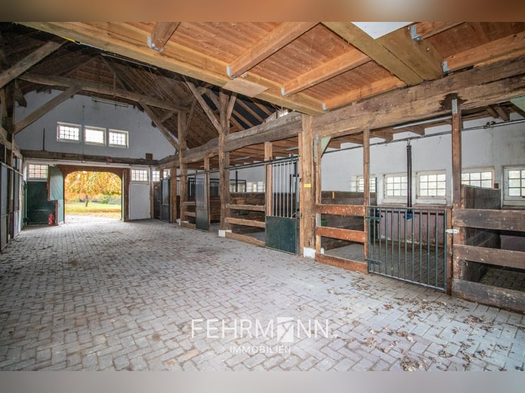 Exclusive estate with a villa, riding facilities, and an indoor arena complex located by a private l