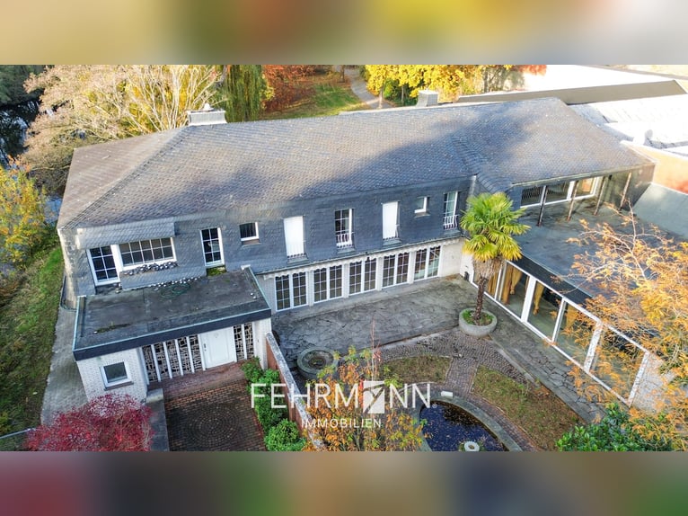 Exclusive estate with a villa, riding facilities, and an indoor arena complex located by a private l