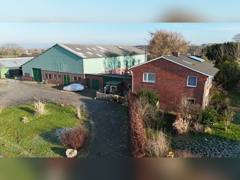 Farm for horse enthusiasts with a residential house in a picturesque village setting